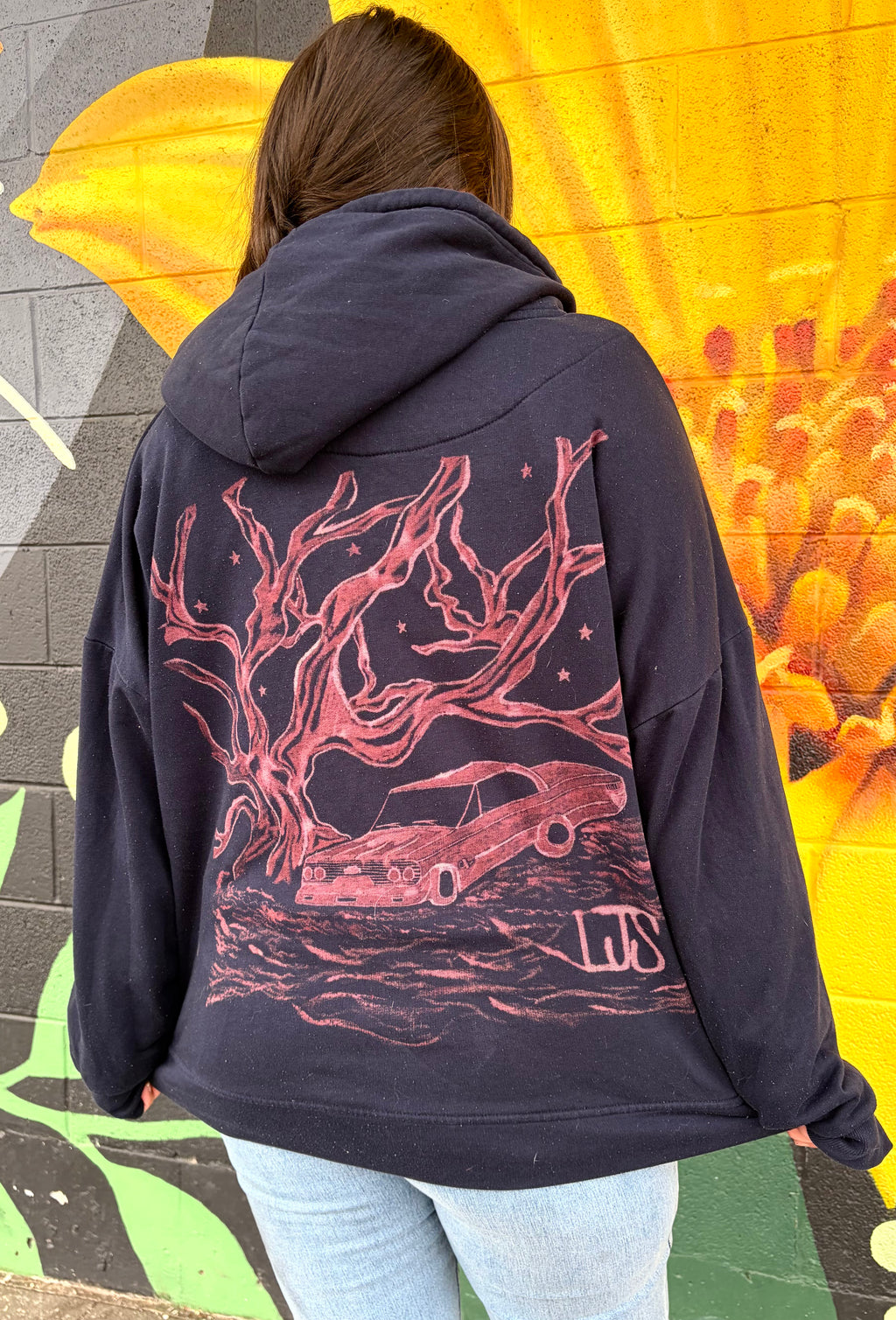 a zip up of a hand-painted lowrider under the stars and an oak tree