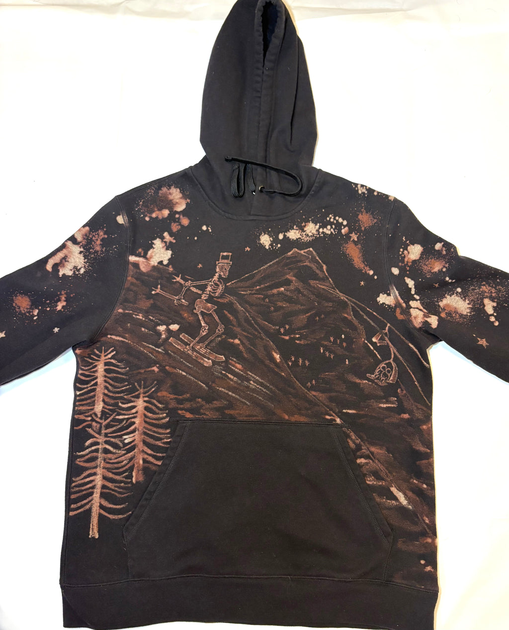 hand-painted bleach art on black hoodie skeleton ski going down slope 