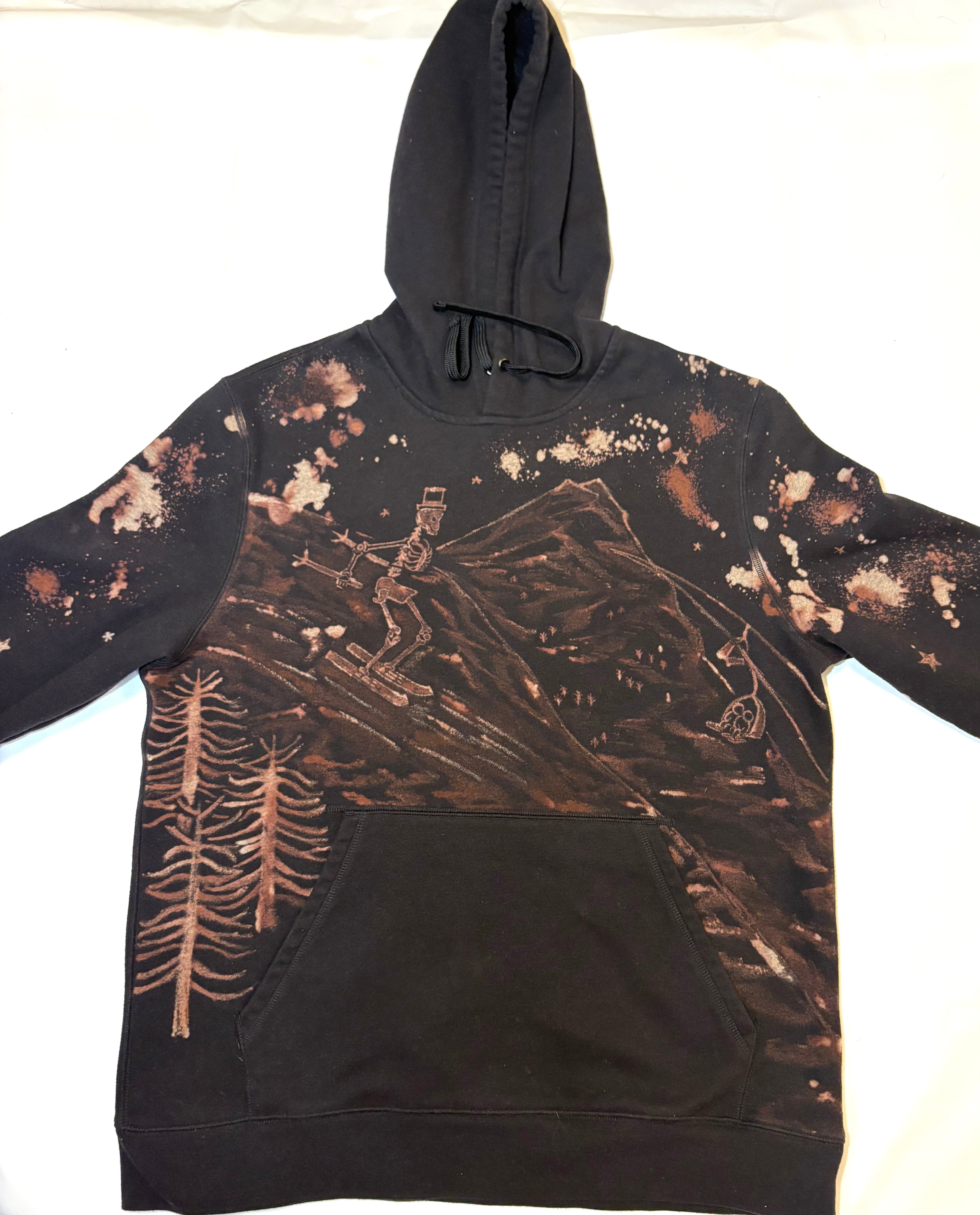 hand-painted bleach art on black hoodie skeleton ski going down slope 
