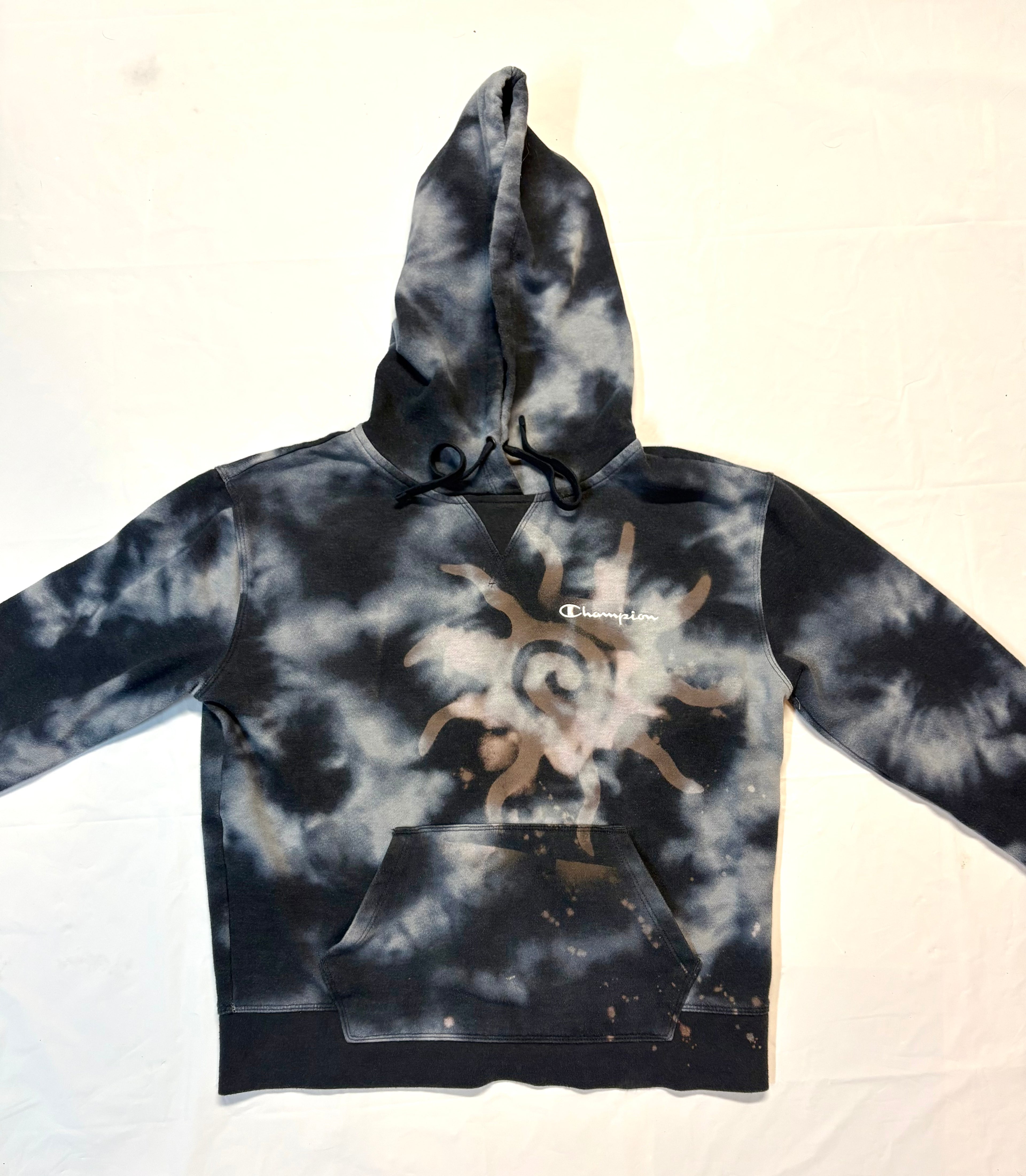 Tie-dye hoodie with a sun design on a white background