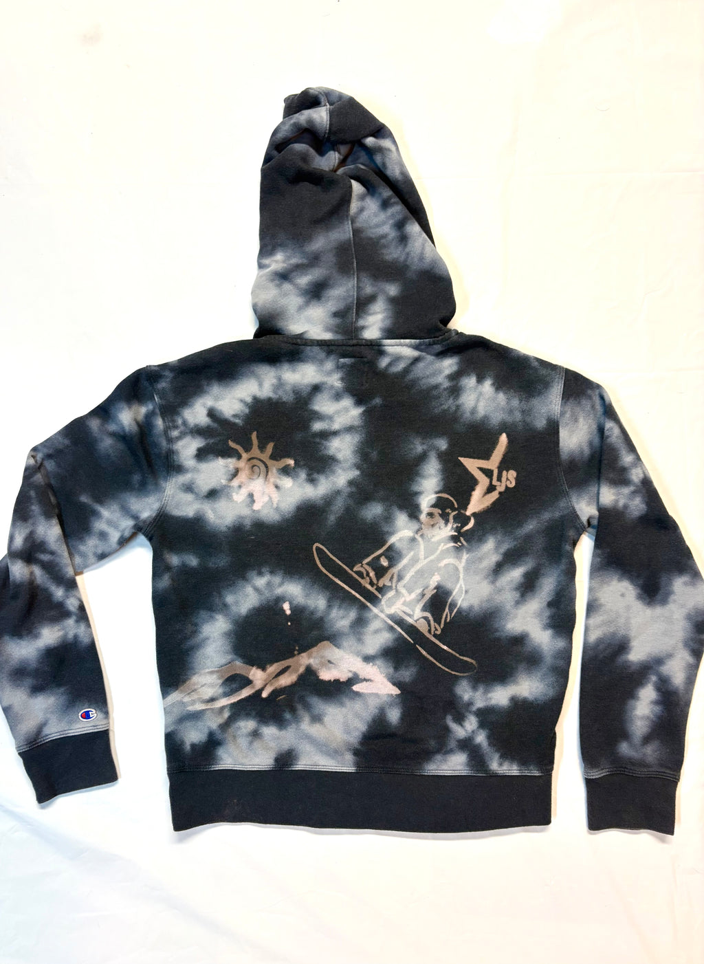 tie dye hoodie with snowboard hitting a jump 