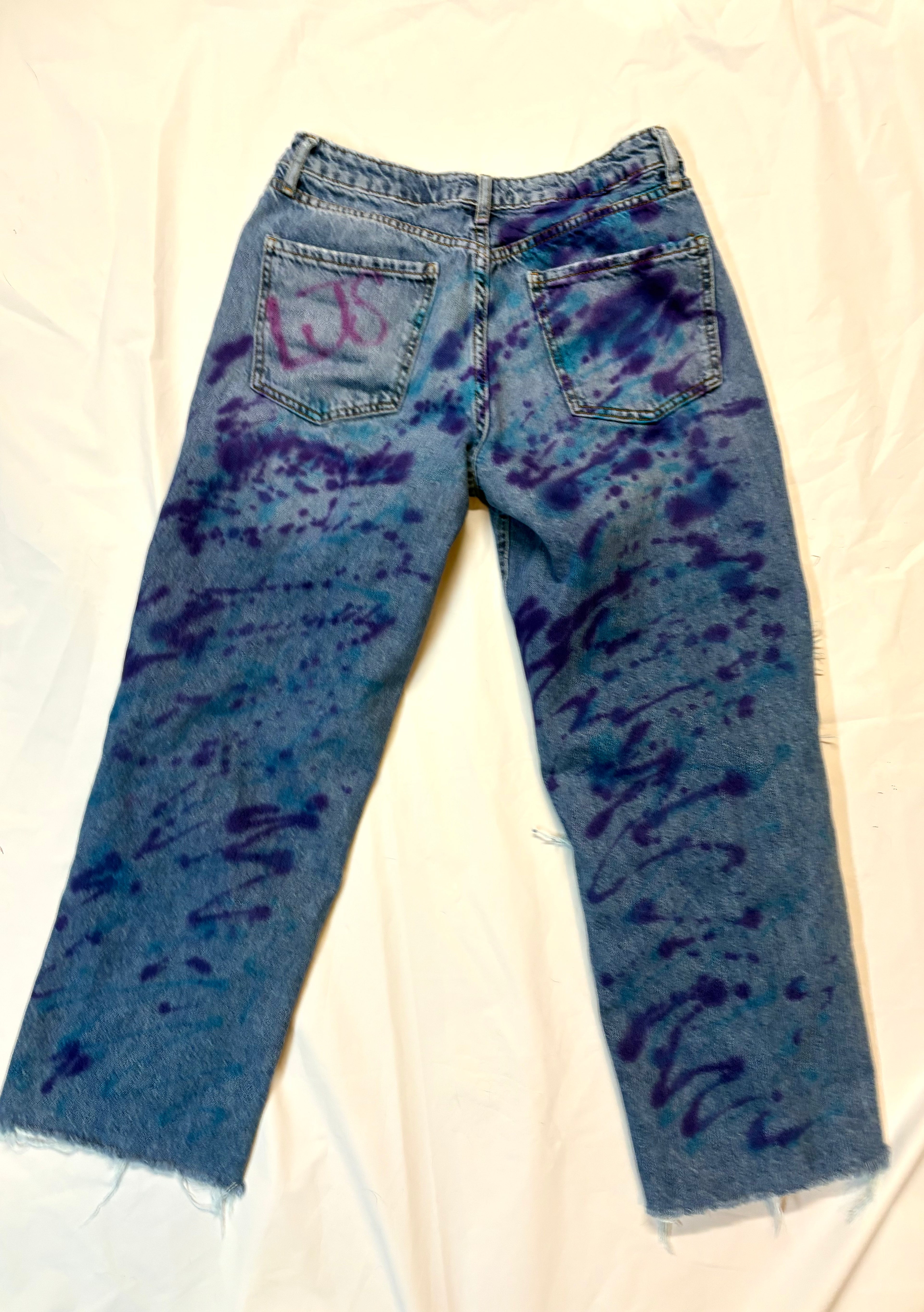 Blue tie-dye jeans on a white background