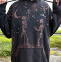Black hoodie with skeleton and stars design worn by a person outdoors